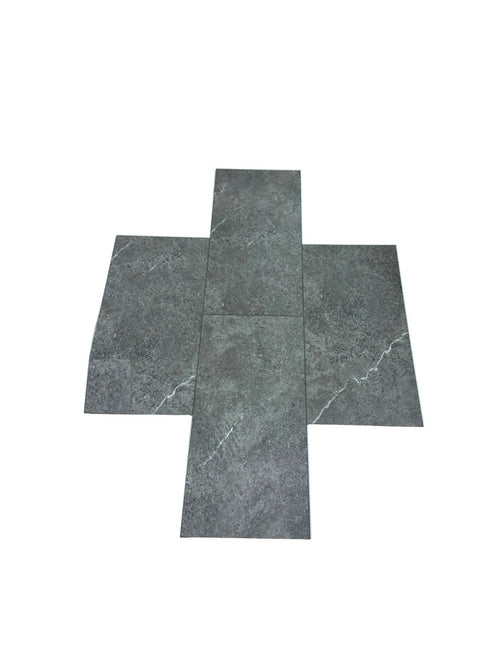Four dark gray stone-look vinyl tiles arranged in a cross-like flat layout on a plain white background. Available at Advanced Flooring.