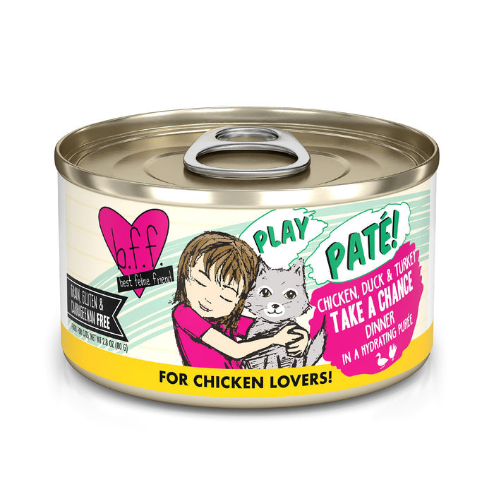 A can of BFF Best Feline Friend Chicken, Duck & Turkey Take a Chance cat food shows a girl hugging a gray cat. The label features playful pink and green text, highlights grain free, cage-free ingredients, and says "For Chicken Lovers!.
