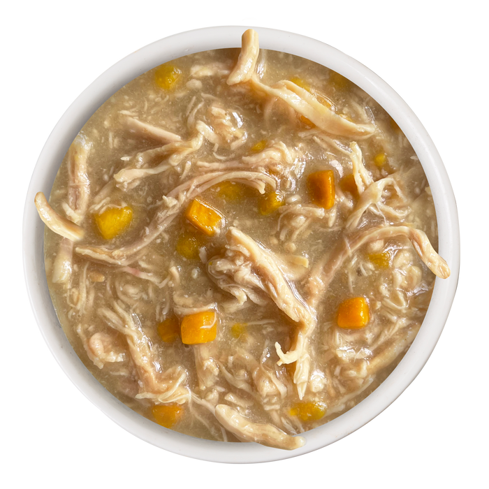 Weruva Chicken Formula in Gravy: tender shredded chicken breast and diced yellow veggies in a thick, light brown broth—ideal as a nutritious senior cat food that supports joint health.