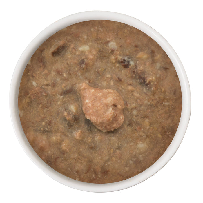 A white bowl filled with brown, chunky BFF Best Feline Friend Chicken & Lamb Selfie Cam! wet food made with cage-free chicken and lamb sits ready for gravy-loving cats, viewed from above with a mound in the center.