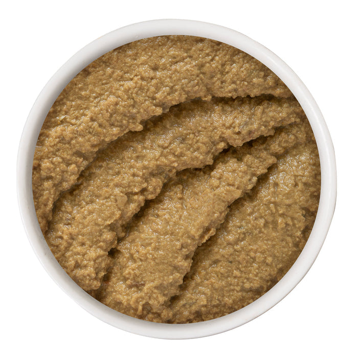 A white bowl filled with smooth, brownish Chicken & Tuna Til' Then by BFF Best Feline Friend is shown from above. The grain-free paste features textured lines and ridges on its surface, made with a utensil.