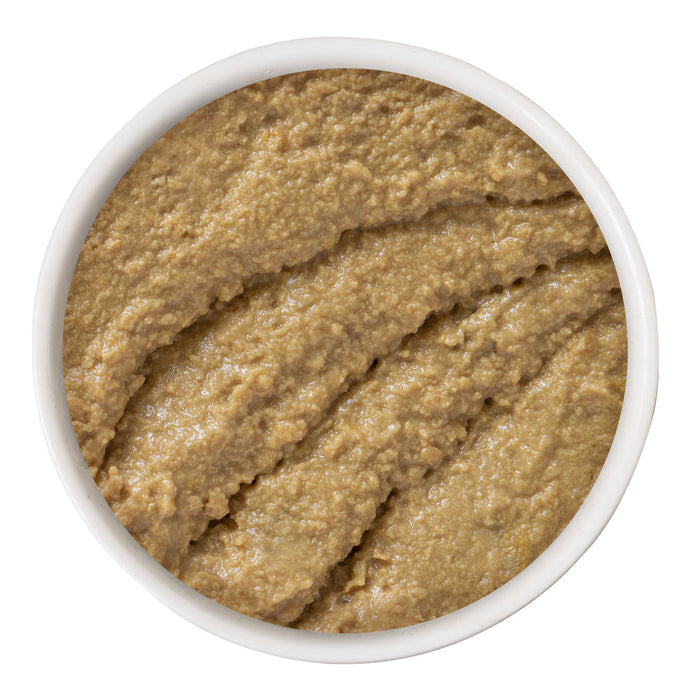 A white bowl holds smooth, light brown Chicken & Turkey Topsy Turvy pâté by BFF Best Feline Friend, textured with curved lines and made from wholesome cage-free chicken.