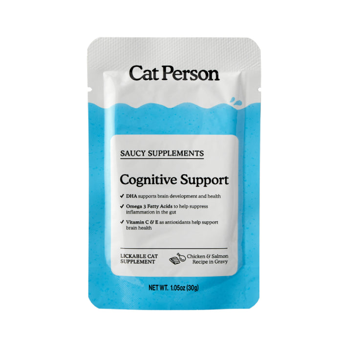 A white and blue packet labeled “Cat Person Cognitive Support Supplement” offers brain health benefits with DHA, Omega 3, and antioxidant Vitamins C/E. This lickable cat food features a chicken and salmon recipe in gravy.