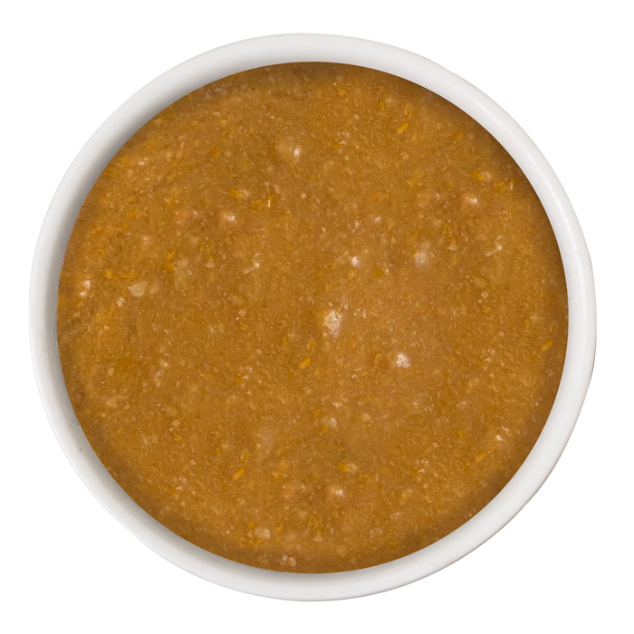 A white bowl filled with Cat Person Cognitive Support Supplement, a thick, brownish-orange puree rich in DHA and antioxidants, photographed from above on a white background.