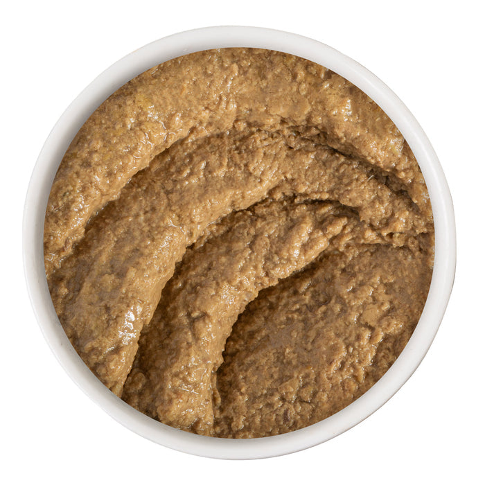 A white bowl filled with BFF Best Feline Friend Duck & Tuna Tap Dance, a thick, brown, slightly textured grain-free paste, viewed from above on a white background.