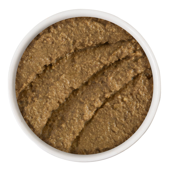 A bowl filled with smooth, brown Duck & Tuna Trickster pâté by BFF Best Feline Friend is shown from above on a white background.