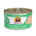A can of Weruva Green Eggs & Chicken cat food—grain, gluten, and carrageenan free—for obligate carnivores, with shredded chicken in pea soup. Features three cat silhouettes and "A Family Owned Company" on the label.