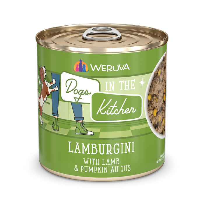 A can of Dogs in the Kitchen Lamburgini dog food, featuring grass-fed lamb and pumpkin au jus. The label shows a cartoon dog and person, with a portion of the meal visible on the right side.