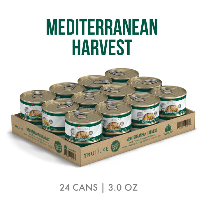 A cardboard tray holds 24 TruLuxe Mediterranean Harvest cans—each 3.0 oz—with hand-flaked tuna and vegetables. The green and white cans display "Mediterranean Harvest" above and "24 cans | 3.0 oz" below.