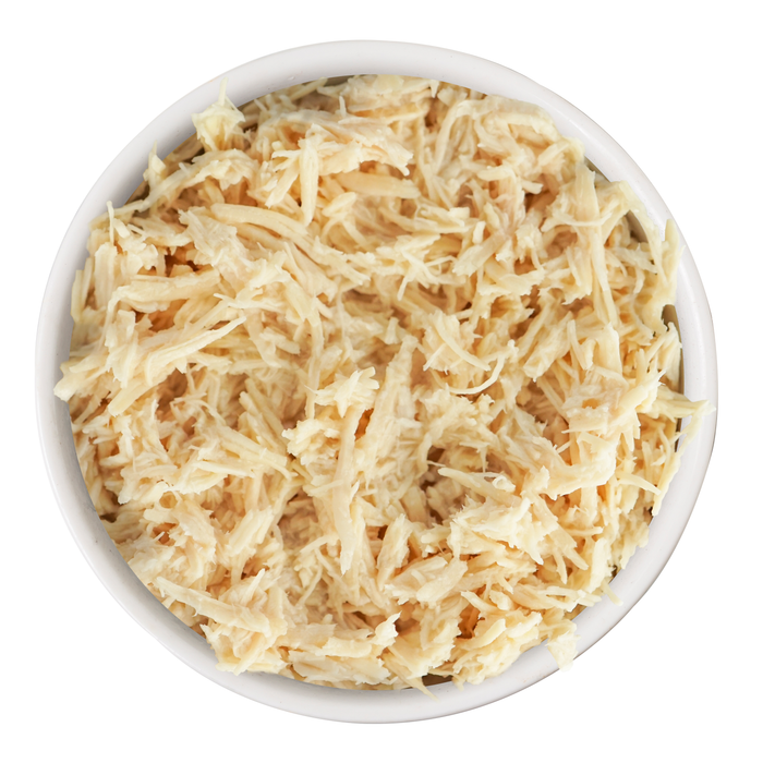A bowl filled with Weruva's Paw Lickin' Chicken shredded white meat dog food is shown from above on a plain white background.