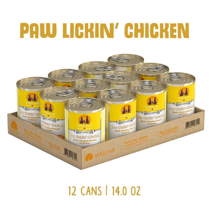 A cardboard tray holds 12 cans of Weruva Paw Lickin' Chicken, a white meat chicken dog food in savory gravy. The yellow and silver cans feature high-quality ingredients. Text above reads Paw Lickin' Chicken, below says 12 cans | 14.0 oz.