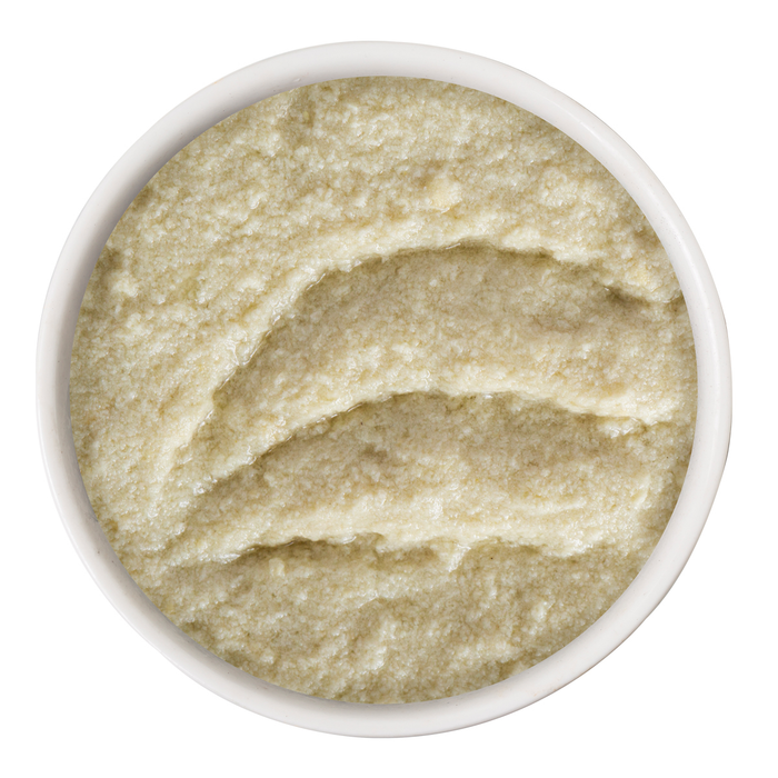 A small white bowl filled with Weruva Press Your Lunch! creamy, pale beige puréed cat food with a slightly coarse texture, viewed from above against a white background.
