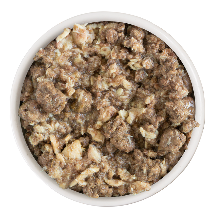 Overhead view of a bowl filled with Soulistic Seaside Serenity cat food, showcasing chunky, moist brown and beige pieces with a hearty stew-like texture.