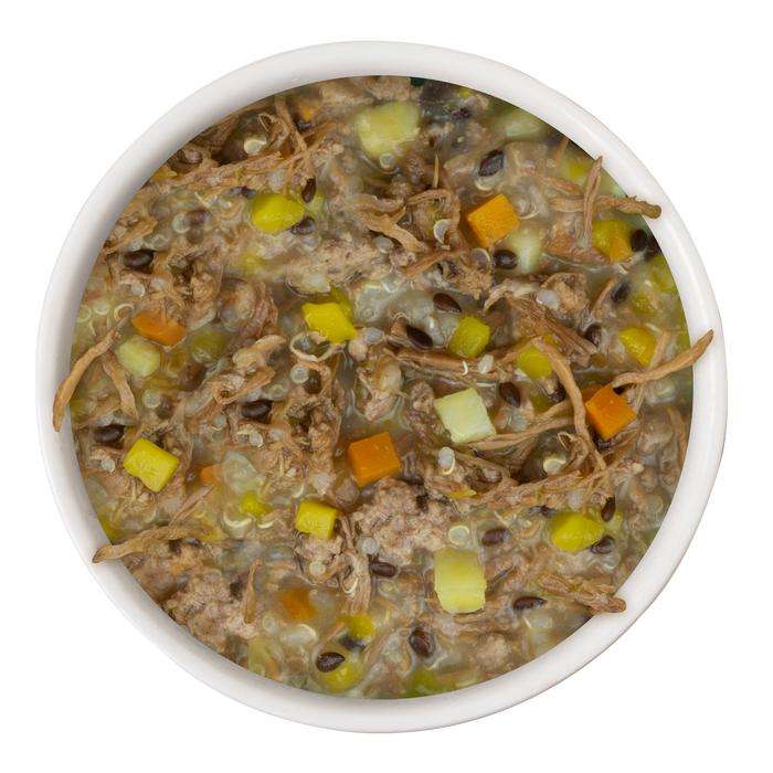 A white bowl filled with Weruva Steak Frites Recipe Plus—grass-fed beef dog food with diced veggies, grains, and broth—viewed from above against a white background; a convenient meal promoting healthy skin and a shiny coat.
