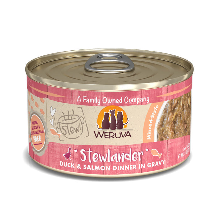 A can of Weruva Stewlander, a mince-style cat food with cage-free duck and wild-caught salmon in gravy. It features a gold lid, pink label with pet silhouettes, and is free from grain, gluten, and carrageenan.
