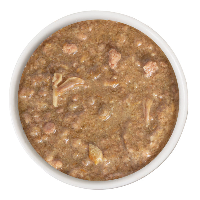 A white bowl filled with Weruva Stewlander wet food, featuring small pieces of cage-free duck in gravy, viewed from above on a white background.