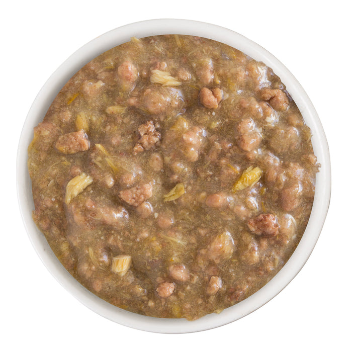 A bowl of Weruva Stir the Pot, chunky brownish wet pet food with small meat pieces and gravy, enriched with omega-3 fatty acids, viewed from above on a white background.