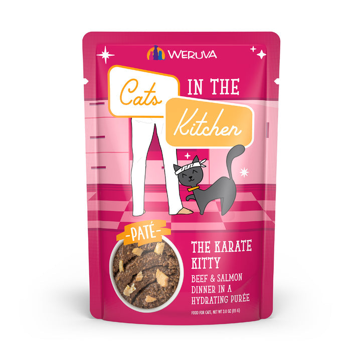A pink pouch of Cats in the Kitchen The Karate Kitty cat food features a black cat with a headband by a person’s legs. The creamy paté is made with grass-fed beef and wild-caught salmon in a hydrating purée.