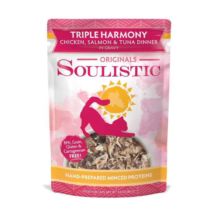 A pouch of Soulistic Triple Harmony cat food features high-protein chicken, salmon & tuna in gravy, a pink design with cat silhouette, and “Hand-Prepared Minced Proteins” on the label.