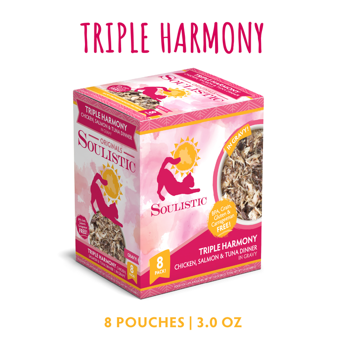 A box of Soulistic Triple Harmony cat food includes 8 pouches (3.0 oz each) with chicken, salmon, and tuna in gravy. Packaging features a pink and yellow design with a cat silhouette and food image.