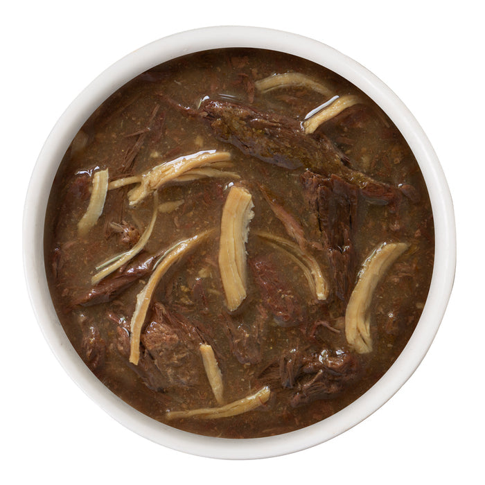 A white bowl of dark broth featuring shredded chicken and thin strips, perfect for gravy-loving cats, showcases BFF Best Feline Friend Tuna & Chicken Charm Me, viewed from above on a white background.