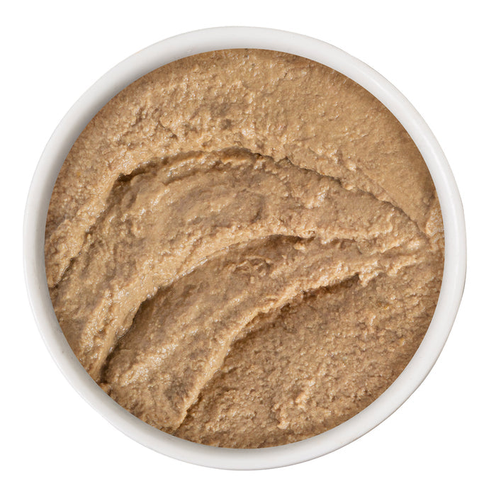 A white bowl filled with BFF Best Feline Friend Tuna & Chicken Check Please!—a smooth, brown pâté made with wild-caught tuna and chicken—viewed from above on a white background.