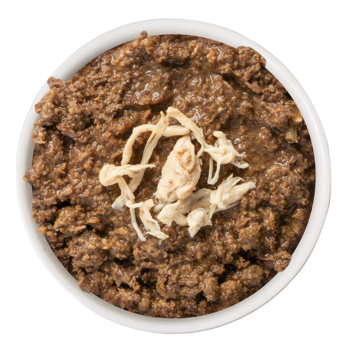 A bowl of BFF Best Feline Friend Tuna & Chicken Chuckles cat food, featuring chunky brown entrée and shredded white chicken breast, is shown from above on a white background.