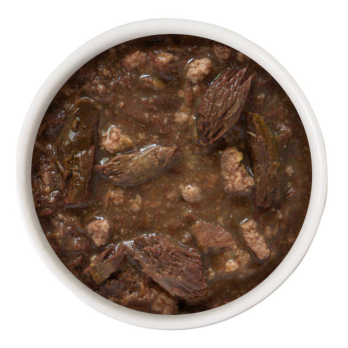 A bowl of BFF Best Feline Friend Tuna & Duck Devour Me, a chunky brown stew with pieces of duck and whole morel mushrooms, perfect for gravy-loving cats, viewed from above on a white background.
