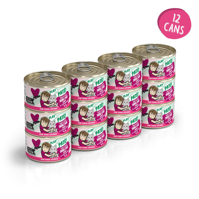 Twelve cans of BFF Best Feline Friend Tuna & Duck Double Dare cat food, with labels facing forward, are arranged in rows. A circular pink label in the top right corner reads "12 cans.