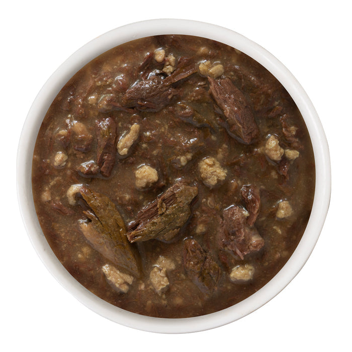 A white bowl filled with dark brown, chunky BFF Best Feline Friend Tuna & Turkey Tickles stew, featuring wild-caught tuna in savory gravy—ideal for cats who love sauce—photographed from above on a white background.