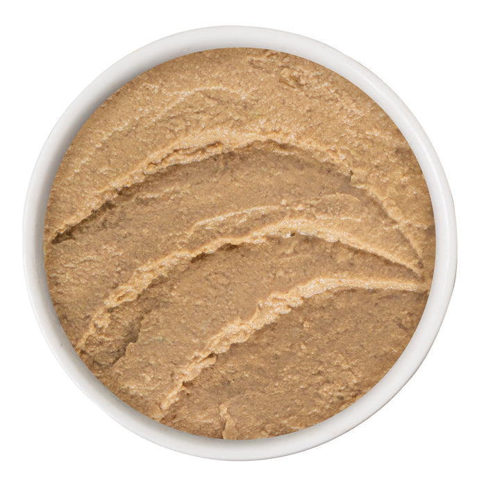 A white bowl filled with smooth, light brown BFF Best Feline Friend Tuna & Turkey T.T.Y.L. pâté made from wild-caught tuna is shown from above, its surface marked by three curved grooves.