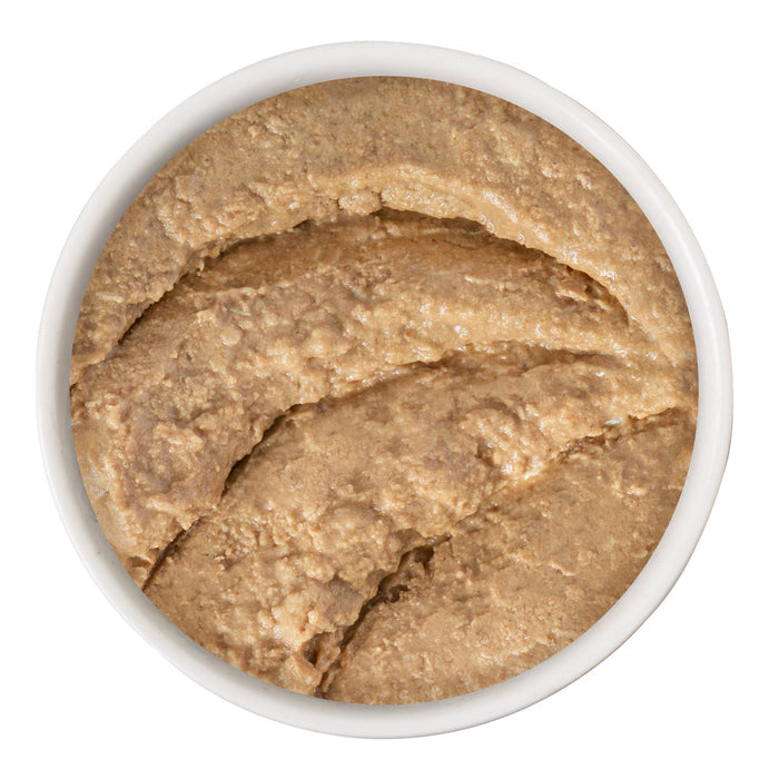 A bowl filled with creamy, light brown Turkey & Tuna Tweet Me! by BFF Best Feline Friend, showing a smooth, thick texture with swirls on top, viewed from above against a white background.