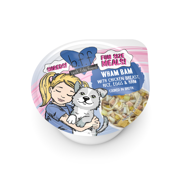 A small BFF Best Fido Friend Wham Bam dog dinner features an illustrated girl hugging a happy dog. The label reads “WHAM BAM with chicken breast, rice, eggs & ham, cooked in broth.” Meal is visible through a window.