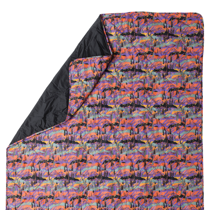 Colorful patterned quilt with black interior on a white background